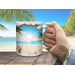 Lifestyle image of a person enjoying coffee in a beach setting.